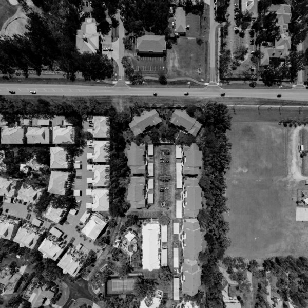 A monochrome aerial photo showcasing a suburban neighborhood layout.